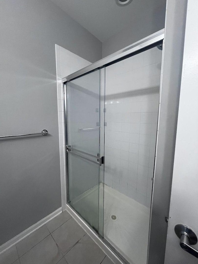 bathroom with tile patterned floors and an enclosed shower