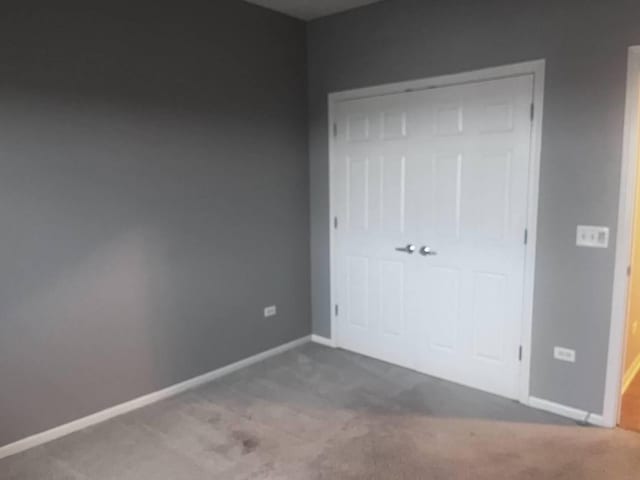 unfurnished bedroom featuring carpet flooring and a closet