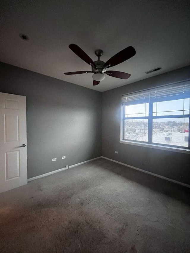 empty room featuring carpet flooring and ceiling fan