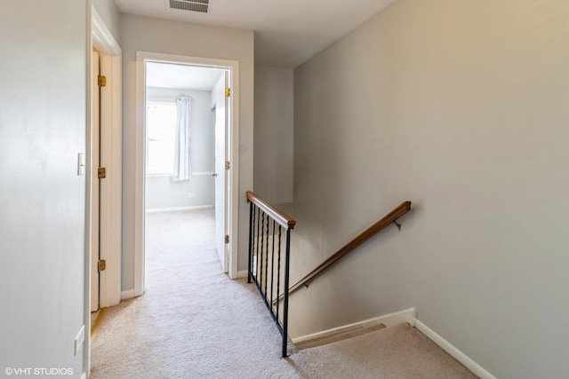 corridor featuring light carpet