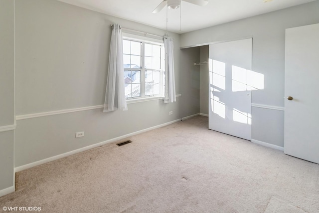 empty room featuring light carpet and ceiling fan