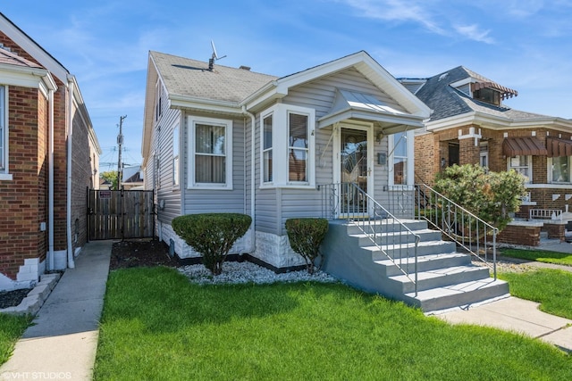 bungalow-style home featuring a front yard