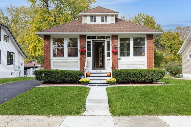 bungalow-style home featuring a front yard