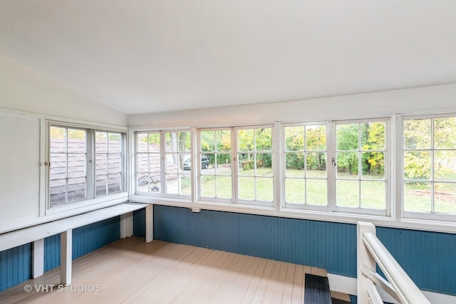 unfurnished sunroom with lofted ceiling