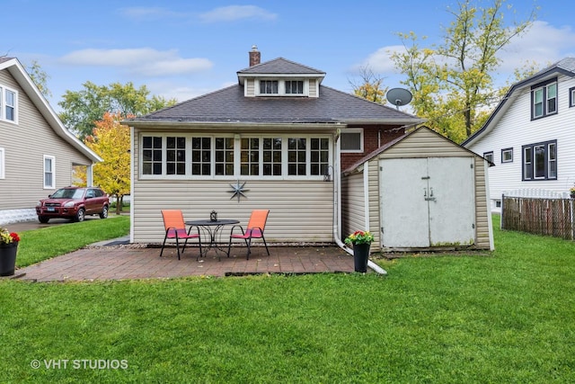 back of house featuring a lawn and a patio area