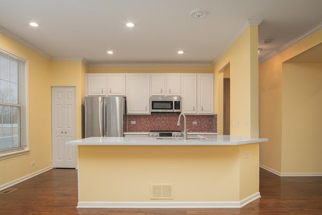 kitchen featuring white cabinetry, sink, an island with sink, and appliances with stainless steel finishes