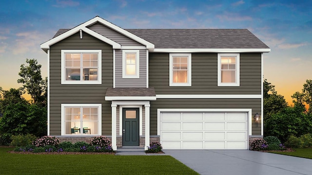 view of front facade featuring a lawn and a garage