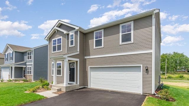 view of front of house featuring a garage and a front lawn