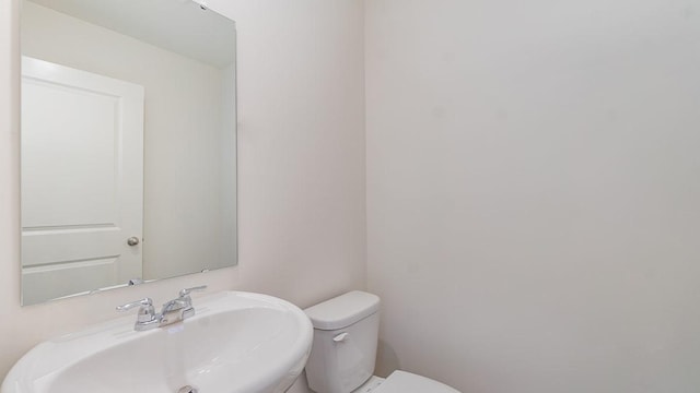 bathroom featuring sink and toilet