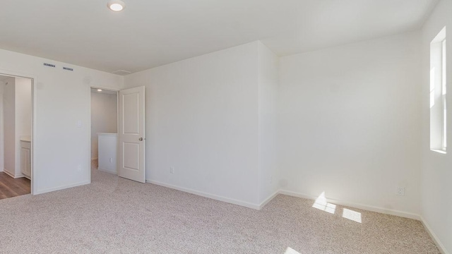 unfurnished bedroom featuring light carpet