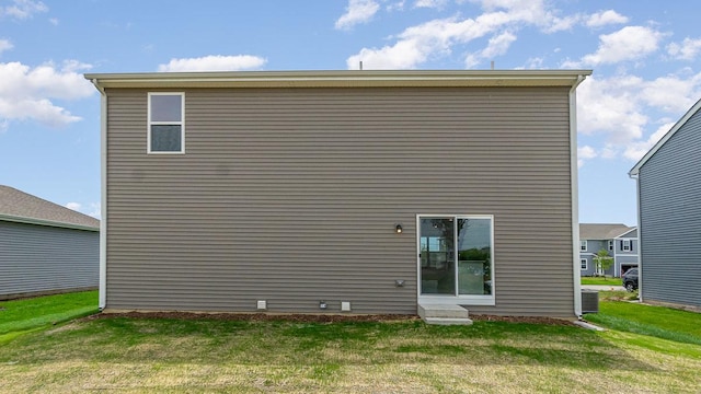 rear view of house with a yard