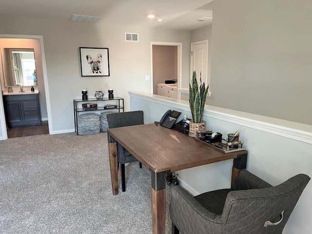 carpeted office featuring washer / clothes dryer and sink