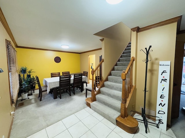 dining space featuring light carpet and crown molding