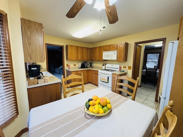 kitchen with ceiling fan, white appliances, and light tile patterned floors