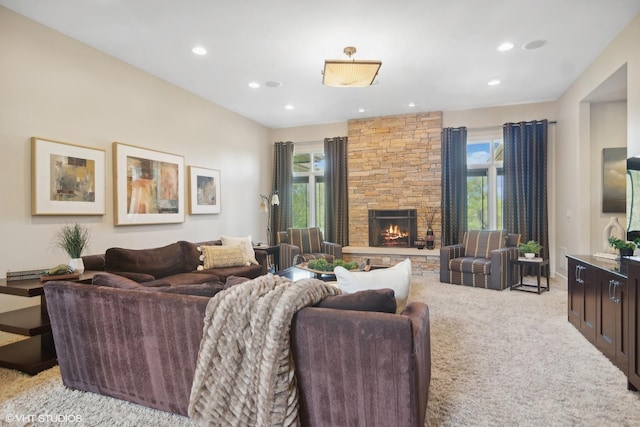 living room featuring light carpet and a fireplace