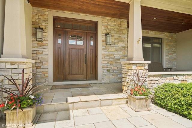 view of exterior entry with covered porch