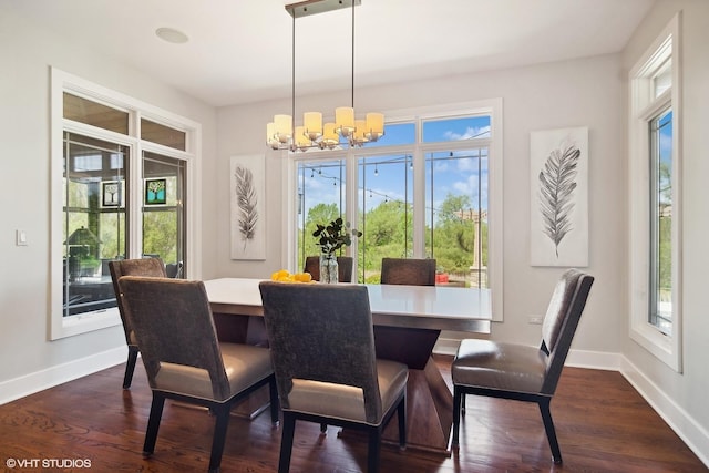 dining space featuring a chandelier and dark wood-type flooring