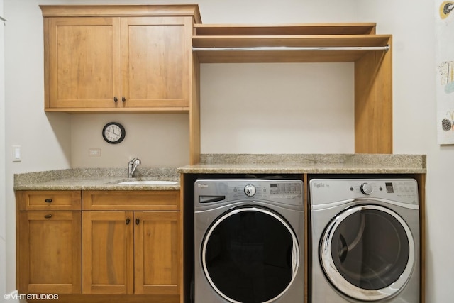 laundry area with cabinets, sink, and washing machine and clothes dryer