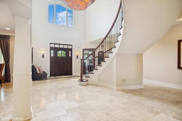 foyer with a towering ceiling and a healthy amount of sunlight