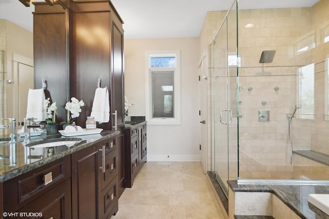 bathroom featuring vanity, tile patterned floors, and a shower with door