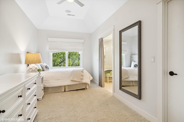 bedroom featuring ceiling fan, a raised ceiling, and light carpet