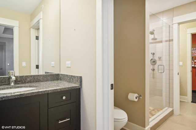 bathroom with tile patterned floors, vanity, toilet, and a shower with door