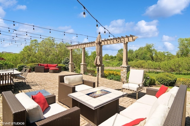 view of patio with an outdoor living space with a fire pit