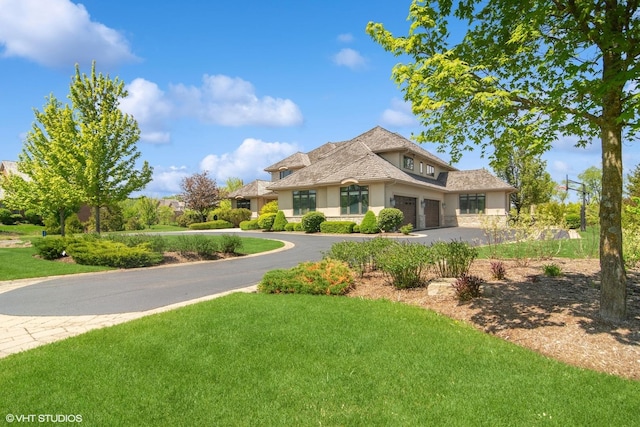 view of front of house with a front yard and a garage