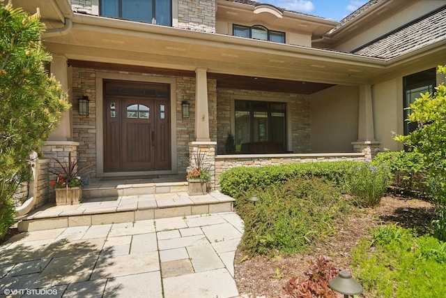 view of exterior entry with covered porch