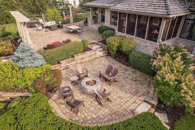 view of yard featuring a fire pit and a patio