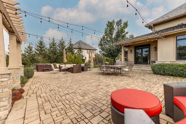 view of patio with an outdoor hangout area and a hot tub