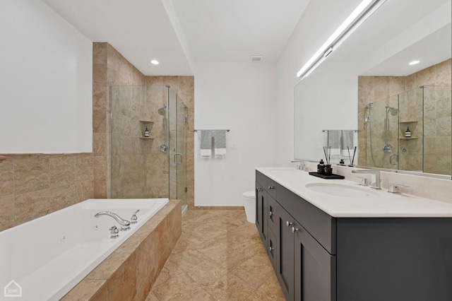 full bathroom featuring vanity, shower with separate bathtub, and toilet