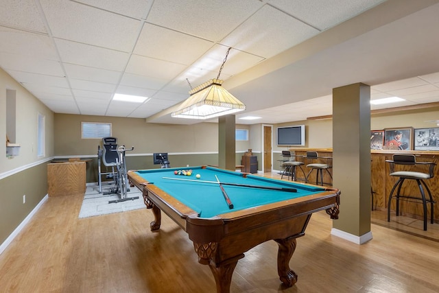 rec room featuring bar, a drop ceiling, billiards, and light hardwood / wood-style flooring