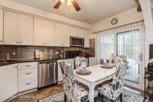 kitchen featuring backsplash, ceiling fan, tile patterned flooring, and appliances with stainless steel finishes