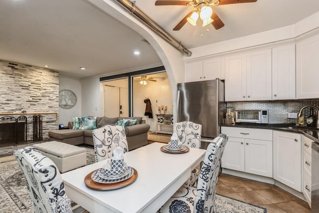 kitchen featuring decorative backsplash, sink, white cabinets, and stainless steel appliances