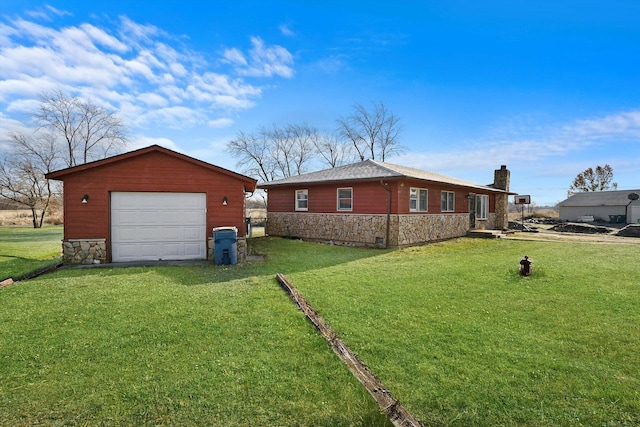 view of home's exterior featuring a yard, an outdoor structure, and a garage