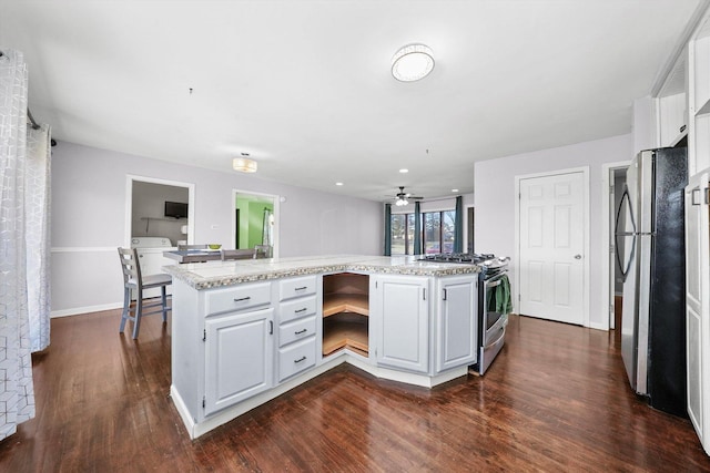 kitchen featuring ceiling fan, dark hardwood / wood-style floors, white cabinetry, and appliances with stainless steel finishes