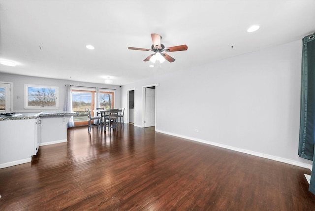 unfurnished living room with dark hardwood / wood-style floors and ceiling fan