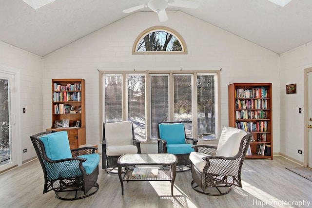 sitting room featuring light wood-type flooring, high vaulted ceiling, and ceiling fan