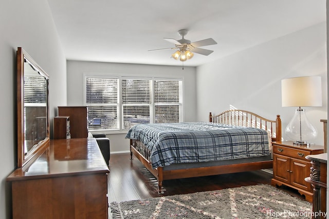 bedroom with dark hardwood / wood-style flooring and ceiling fan