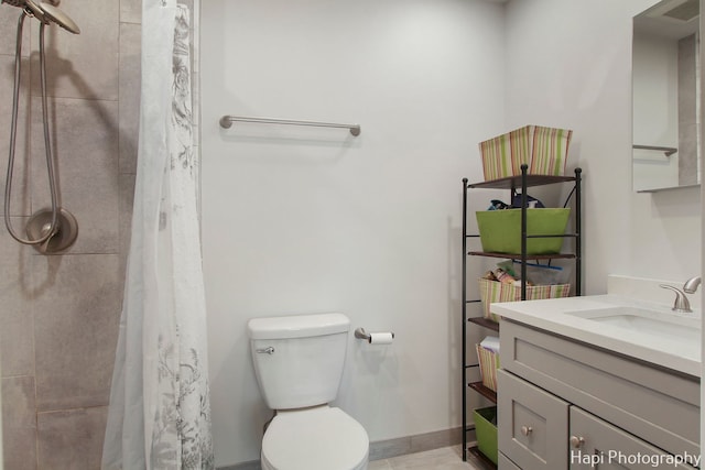 bathroom with vanity, toilet, and walk in shower