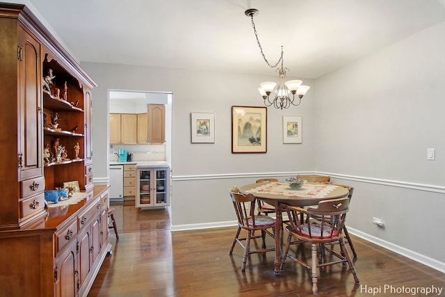 dining space featuring dark hardwood / wood-style floors and an inviting chandelier