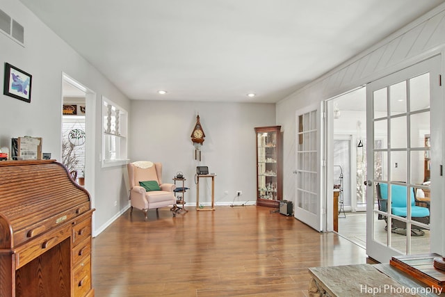 sitting room with hardwood / wood-style floors and french doors