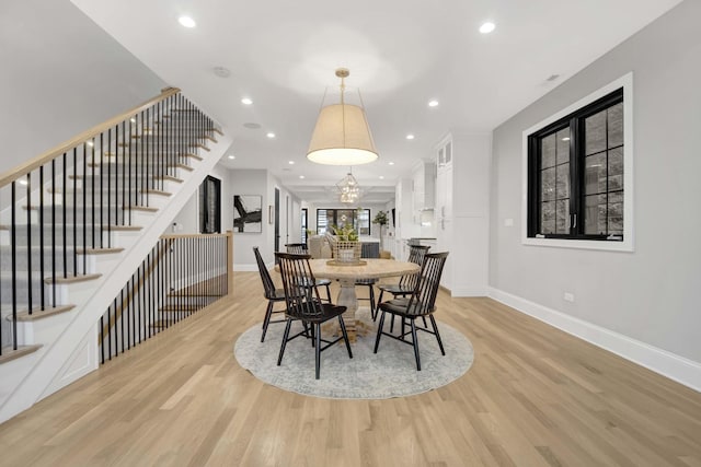 dining room featuring an inviting chandelier and light hardwood / wood-style flooring