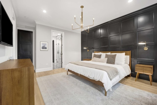 bedroom featuring crown molding, connected bathroom, an inviting chandelier, and light wood-type flooring