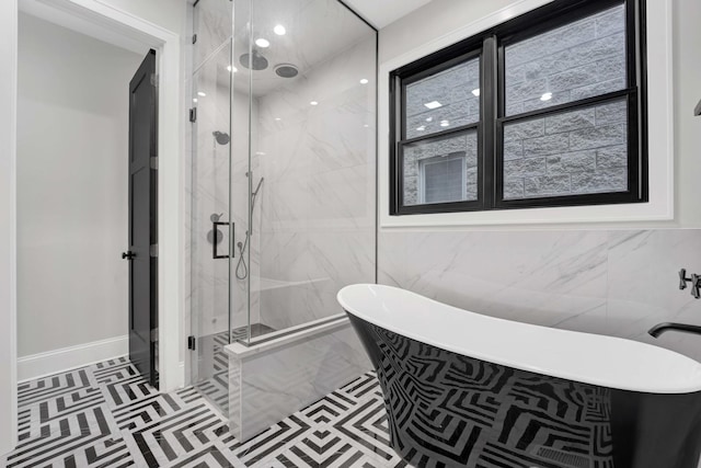 bathroom featuring independent shower and bath, tile patterned flooring, and tile walls