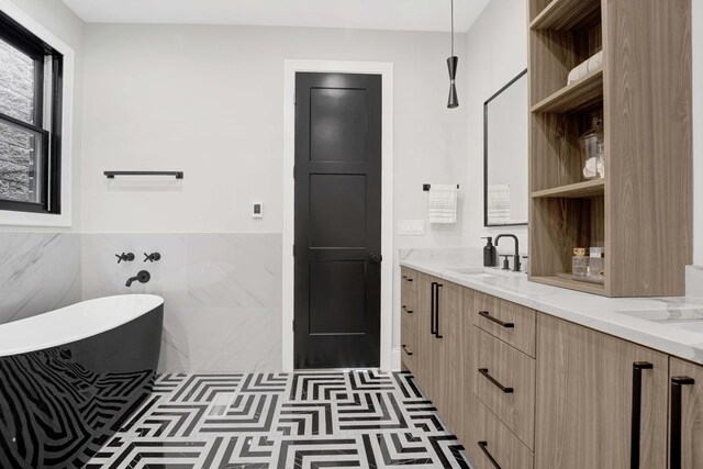 bathroom featuring vanity, tile walls, and a tub