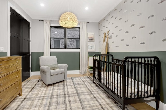 bedroom featuring a nursery area