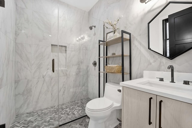 bathroom featuring vanity, toilet, an enclosed shower, and tile walls