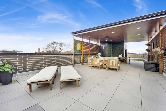 view of patio with outdoor lounge area and ceiling fan